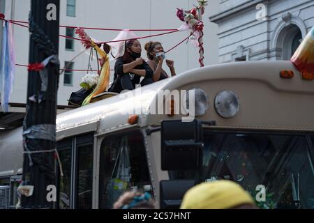 New York, United States. 01st July, 2020. Protesters sit a top of converted school bus parked by City Hall during the protest.Tensions increase ahead of a City Council vote on New York's budget, which is inclusive of the police department budget as protesters affiliated with Black Lives Matter (BLM) and other groups congregate in a protest outside of City Hall in Lower Manhattan as they continue to demand that the New York City Police Department (NYPD) be defunded. Credit: SOPA Images Limited/Alamy Live News Stock Photo