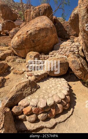 stone road to cave with bushmen rock paintings White Lady in Brandberg mountain area in Namibia with prehistoric archeological sign. Stock Photo