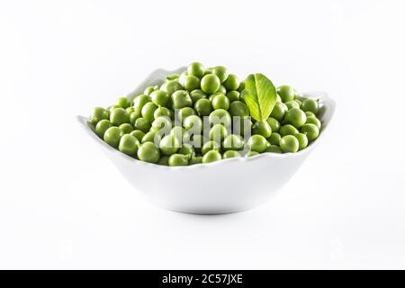 Green raw peas in pocelain bow isolated on white background Stock Photo