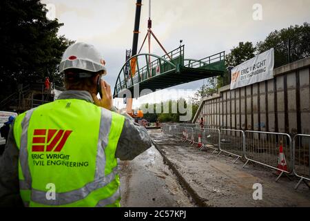 A57 Hyde Road in Gorton has a new footbridge added to the old railway line now Fallowfield cycle loop part of the road widening by Eric Wright Stock Photo