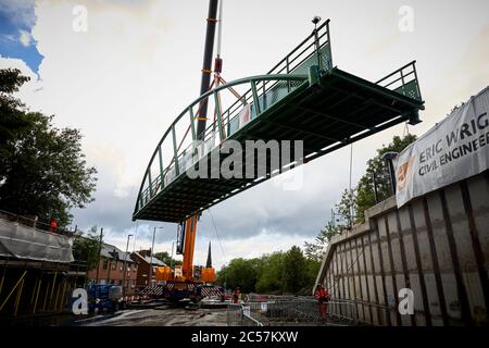 A57 Hyde Road in Gorton has a new footbridge added to the old railway line now Fallowfield cycle loop part of the road widening Stock Photo