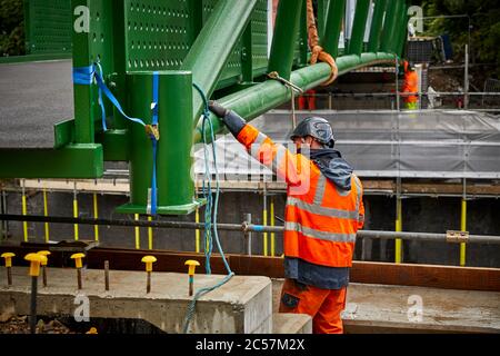 A57 Hyde Road in Gorton has a new footbridge added to the old railway line now Fallowfield cycle loop part of the road widening Stock Photo