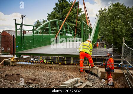 A57 Hyde Road in Gorton has a new footbridge added to the old railway line now Fallowfield cycle loop part of the road widening Stock Photo