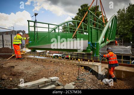A57 Hyde Road in Gorton has a new footbridge added to the old railway line now Fallowfield cycle loop part of the road widening with Stock Photo