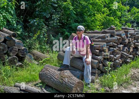 Vršac, hill, Serbia, June 27, 2020. A young woman who is on a mountain walk makes a vacation for herself. After the rest, he continues with a group of Stock Photo