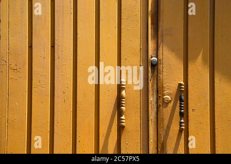 Yellow painted old iron door detail texture Stock Photo