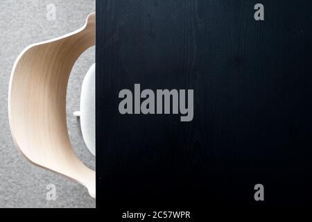 Designers armchair by black office desk. Modern minimalist workplace Stock Photo