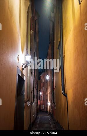 A verticle image of a narow alley in Gamla Stan, Stockholm, Sweden's old town, with colorful 17th and 18th-century buildings and cobblestone streets. Stock Photo