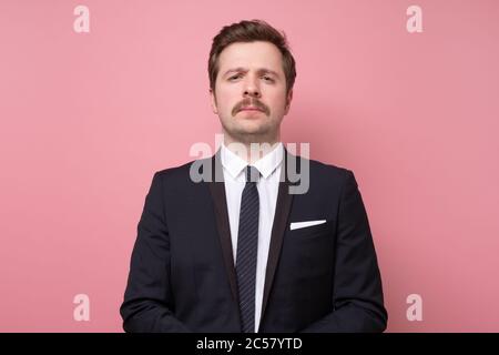 Handsome young man in suit looking at camera serious and confident. Stock Photo