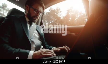 Businessman working laptop traveling car Stock Photo