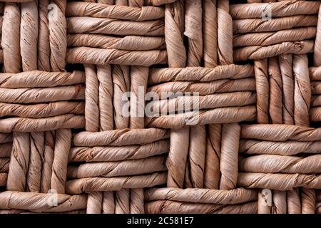 Weaving from dried vegetable fiber. Beautiful texture. Basket weaving. Beautiful, woven pattern of vegetable fiber. Stock Photo