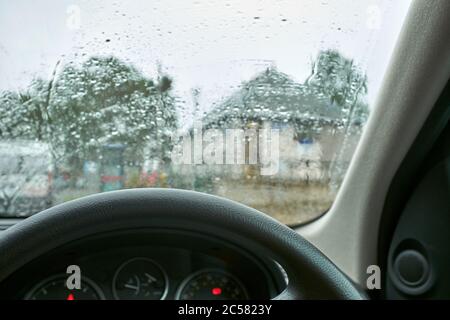 Sheltering in the car during a heavy downpour in July in the centre of Braemar Stock Photo