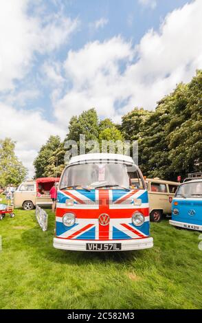 classic Volkswagen Kombi camper van with Union Jack flag painted along sides Stock Photo