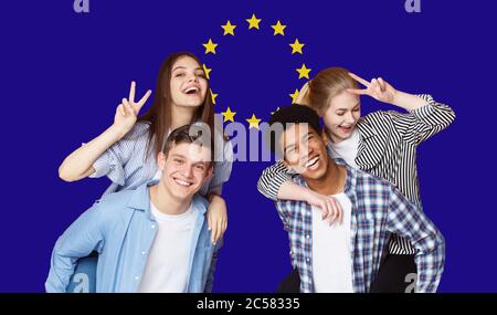 Group Of Happy Multi Ethnic Students Standing In Front Of EU Flag Stock Photo