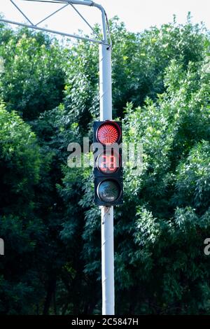 A red traffic light. Street light with stopwatch for drivers and pedestrians. A traffic light with a stopwatch. Road sign. Stock Photo