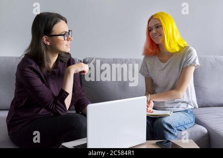 Teen student girl 15, 16 years old has individual lesson from young woman teacher Stock Photo