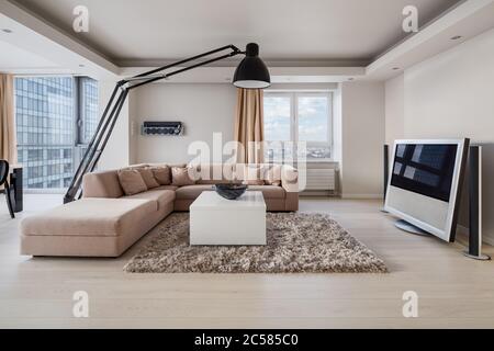Luxury decorated living room interior with big corner sofa and large lamp Stock Photo