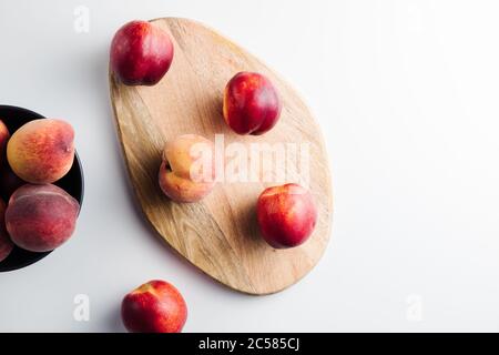 Close-up of ripe peaches on the table. Ripe peaches with leaves Stock Photo