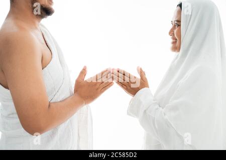 muslim asian couple shake hands. umrah and hajj celebration Stock Photo