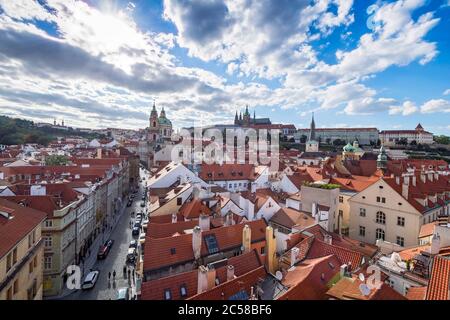 sunny panorama of the Czech capital, Prague, from tower with Prague castle and red roofs houses Stock Photo