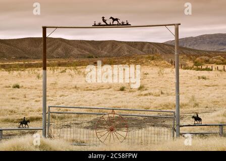 Ranch gate at Chihuahuan Desert near Presidio, Texas, USA with Sierra Grande massif across Rio Grande in Mexico in distance, winter Stock Photo