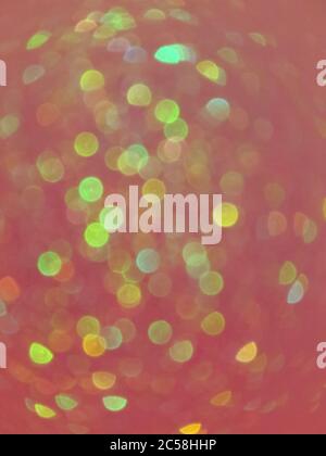 Vertical abstract shot of multicolored bokeh lights on a dark red background for wallpapers Stock Photo
