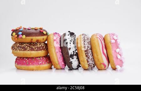 mix of multicolored sweet doughnuts with sprinkles on white background Stock Photo