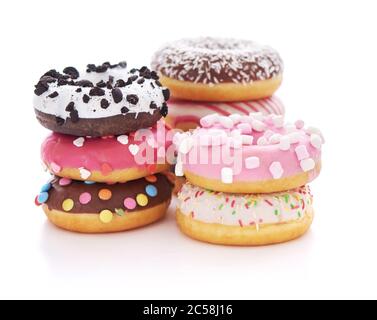 Stack of glazed doughnuts with sprinkles on white background Stock Photo