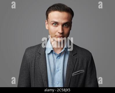 Shocked handsome man with wide opened eyes. Studio isolated Stock Photo