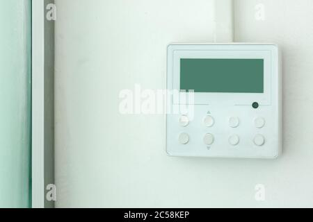 white wall air conditioning control panel with screen and control buttons, close up empty. Stock Photo