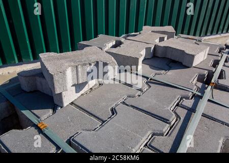 new paving stone tiles gray colore folded and packed on a pallet, close up. Stock Photo