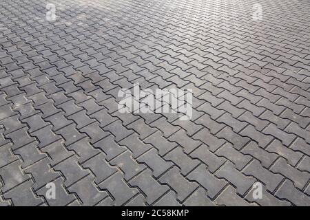 paving slabs of gray color pedestrian square paved with stone, closeup of empty space. Stock Photo