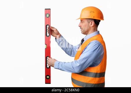 Construction Site Worker Using Builder's Level Working Over White Background Stock Photo