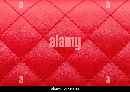square red leather pattern stitched with thread seam, decorative texture of animal skin. Stock Photo