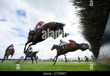 The winner Sangha River ridden by Aidan Coleman (nearest ) vlears a fence before going on to win the signsolutions.org Offering Retail Solutions Novices' Hurdle (GBB Race) (Div 2) at Southwell Racecourse. Stock Photo