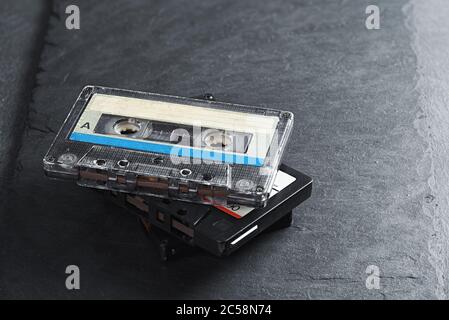 Three audio tape compact cassettes on stone background Stock Photo