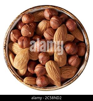 almonds and hazelnuts in a bowl isolated on white with clipping path. Top view Stock Photo