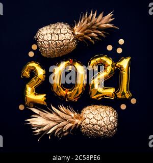 Happy new year 2021 gold foil balloon and pineapple celebration background Stock Photo