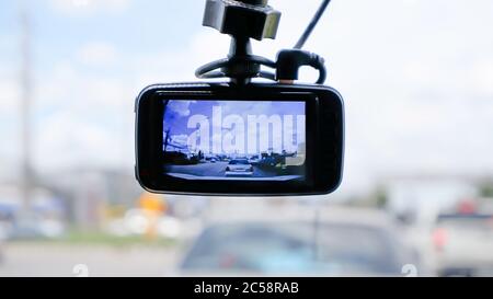 Camera on the front of a car  Background Cars on the road and clouds in the sky. Stock Photo