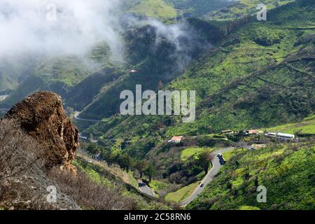 Gran Canaria rural landscape. Serpentine road system among foggy hills at early morning. Stock Photo
