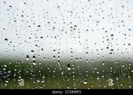 Raindrops on window with out of focus background. Hertfordshire. UK Stock Photo