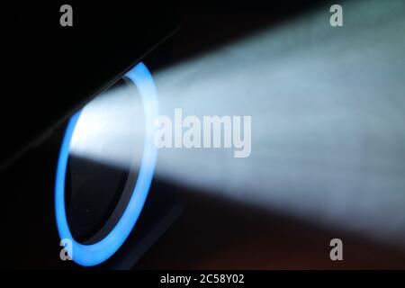 Blue rays of light through the smoke from the projector. Lighting equipment. Show, performance, concert or night club. Abstract Background Stock Photo