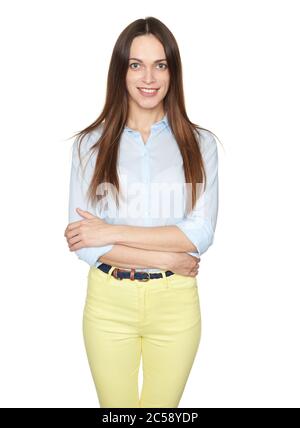 portrait of stylish young pretty caucasian woman in blue shirt and yellow pants is smiling isolated on white studio background Stock Photo