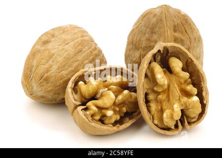 fresh walnuts and a cracked one on a white background Stock Photo