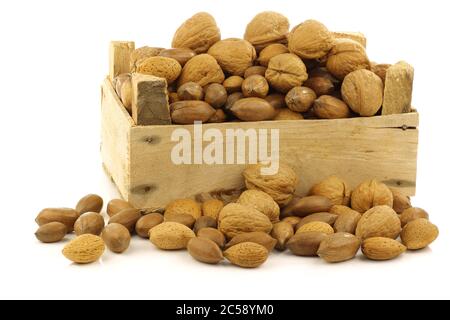 assorted nuts in a wooden box on a white background Stock Photo