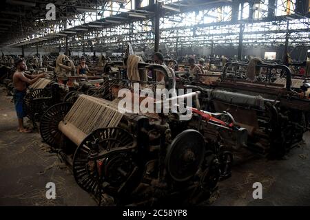 DHAKA, BANGLADESH - 01JULY 2020:  Workers busy in making jute sacks at jute processing mill in Narayanganj near Dhaka,. Jute Industry in Bangladesh is an industry that is historically and culturally important that once was the biggest industry in the region. Stock Photo