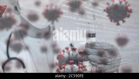 Covid-19 cells and data processing against doctor holding a syringe Stock Photo