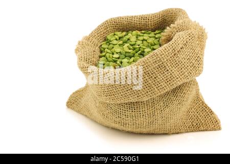 split green peas in a burlap bag on a white background Stock Photo