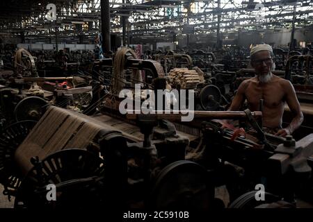 DHAKA, BANGLADESH - 01JULY 2020:  Workers busy in making jute sacks at jute processing mill in Narayanganj near Dhaka,. Jute Industry in Bangladesh is an industry that is historically and culturally important that once was the biggest industry in the region. Stock Photo