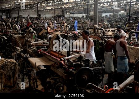 DHAKA, BANGLADESH - 01JULY 2020:  Workers busy in making jute sacks at jute processing mill in Narayanganj near Dhaka,. Jute Industry in Bangladesh is an industry that is historically and culturally important that once was the biggest industry in the region. Stock Photo